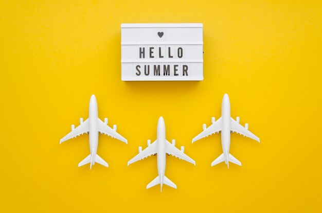 Hola etiqueta de verano con aviones en la mesa