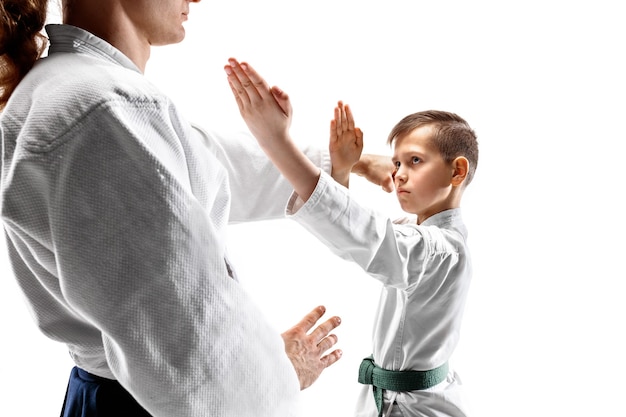 Foto gratuita hombre y adolescente peleando en el entrenamiento de aikido en la escuela de artes marciales. concepto de deporte y estilo de vida saludable.