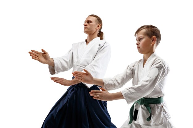 Hombre y adolescente peleando en el entrenamiento de Aikido en la escuela de artes marciales. Concepto de deporte y estilo de vida saludable.