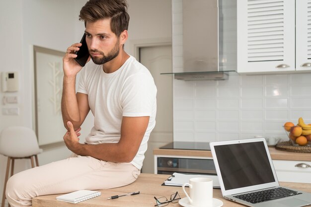 Hombre adulto guapo hablando por teléfono