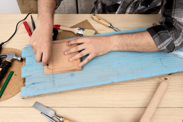 Foto gratuita hombre de alta vista con un lápiz sobre madera