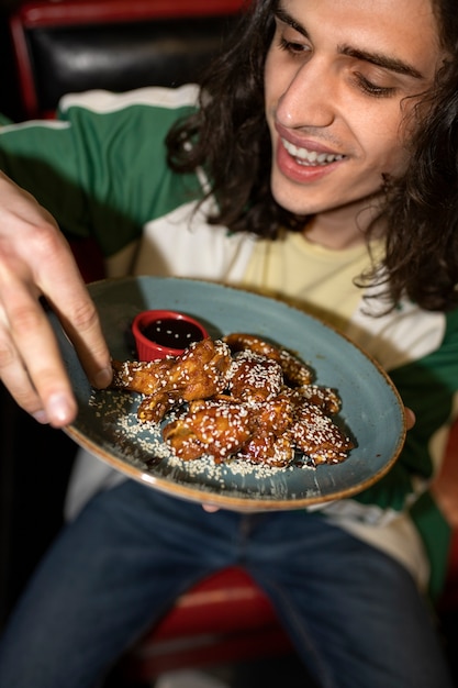 Hombre de alto ángulo comiendo comida rápida