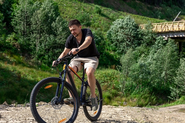 Foto gratuita un hombre anda en bicicleta en una zona montañosa del bosque.