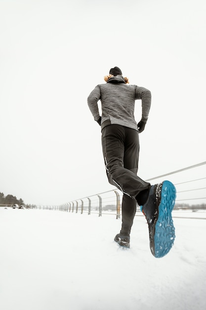 Hombre de ángulo bajo corriendo al aire libre