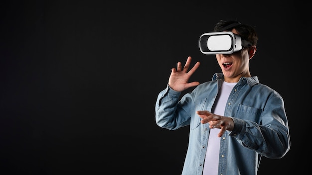 Hombre de ángulo bajo con simulador de realidad virtual