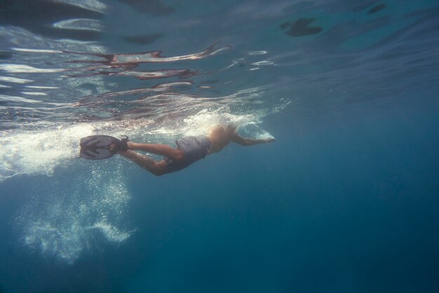 Hombre apnea con aletas bajo el agua