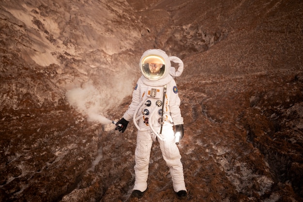 Hombre astronauta señalando su ubicación durante una misión espacial en un planeta desconocido