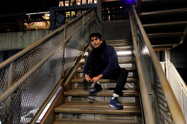 Hombre atándose los cordones para salir a correr por la ciudad