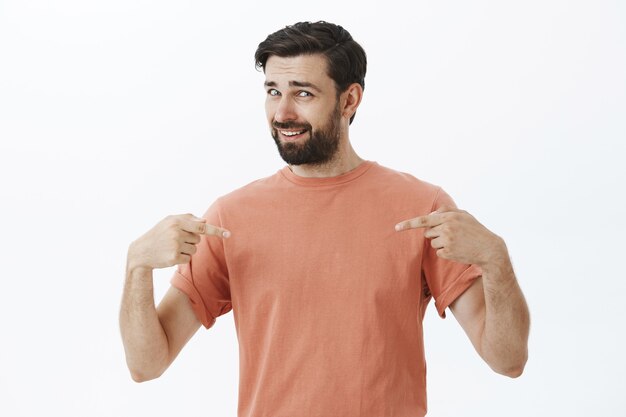 Hombre barbudo expresivo en camiseta naranja