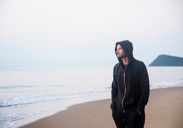 Foto gratuita hombre caminando en soledad en la playa