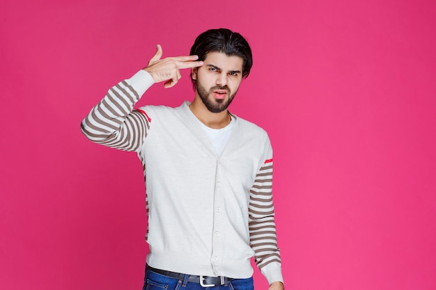 Foto gratuita hombre con camisa blanca haciendo el signo de la paz.