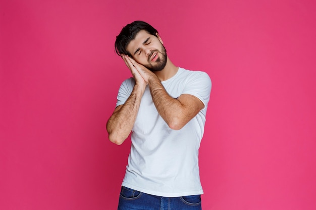 El hombre de camisa blanca no puede dejar de dormir de pie.