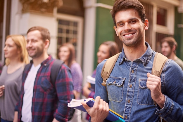 Hombre en el campus universitario con colegas