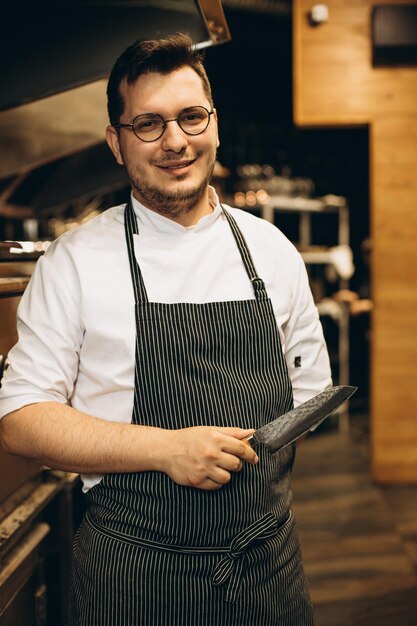 Hombre chef en la cocina con su cuchillo.