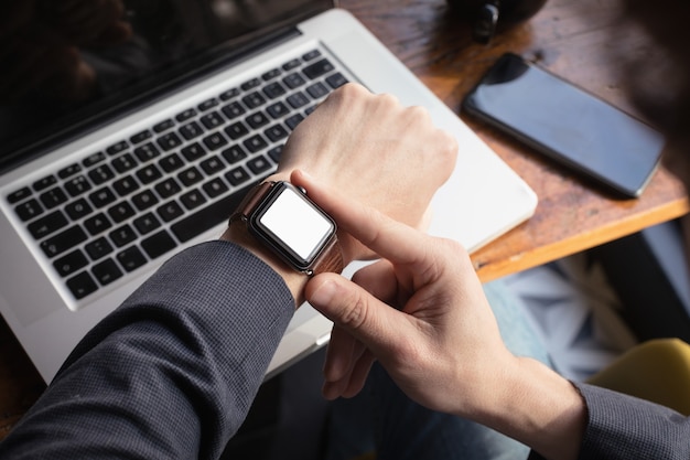 Hombre comprobando el tiempo en el reloj inteligente