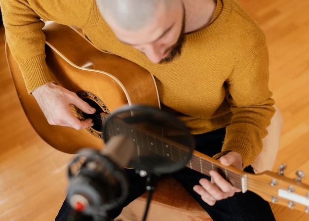 Hombre creativo practicando una canción en casa