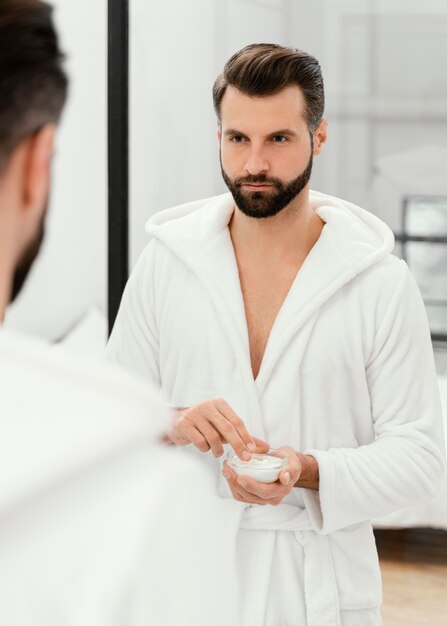 Hombre cuidando bien su rostro en casa