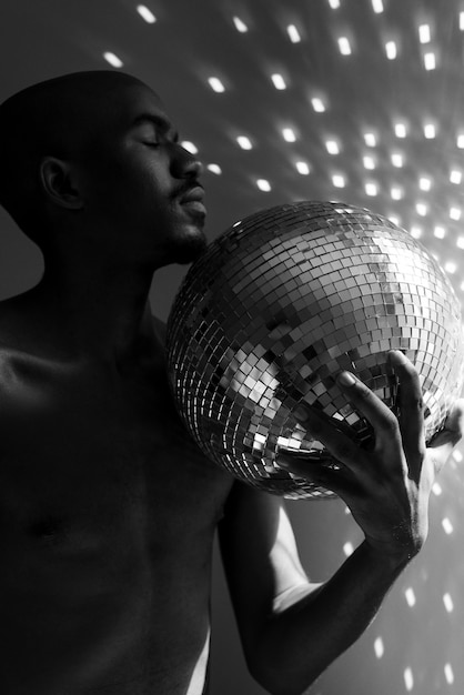 Foto gratuita hombre desnudo de tiro medio posando con bola de discoteca