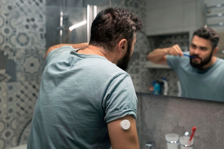 Foto gratuito hombre diabético con sensor de parche de glucosa lavándose los dientes