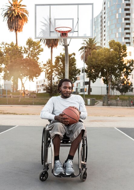 Hombre discapacitado en silla de ruedas jugando baloncesto