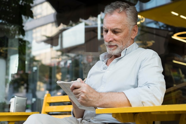 Foto gratuita hombre disfrutando de un juego de sudoku en papel