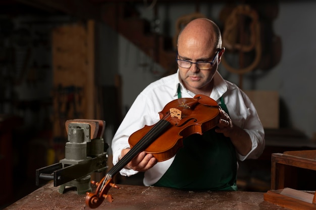 Hombre elaborando un instrumento en su taller.