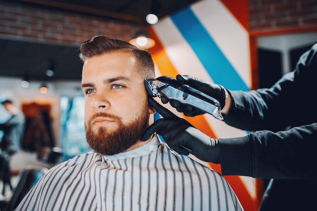 Hombre elegante sentado en una barbería