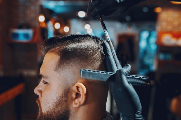 Hombre elegante sentado en una barbería