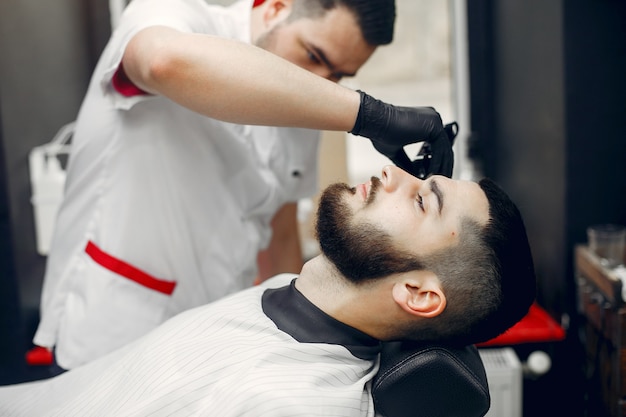 Foto gratuita hombre elegante sentado en una barbería