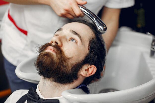 Hombre elegante sentado en una barbería