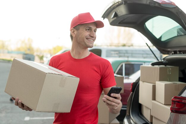 Hombre de entrega de tiro medio trabajando