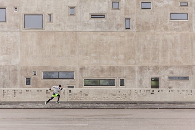 Hombre esprintando en ambiente urbano