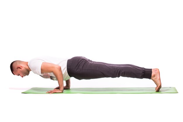 El hombre está haciendo yoga aislado sobre fondo blanco.