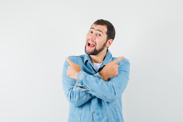 Hombre de estilo retro apuntando a izquierda y derecha con los brazos cruzados en chaqueta, camiseta y mirando confundido. vista frontal.