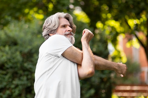 Foto gratuita hombre estirando en la naturaleza