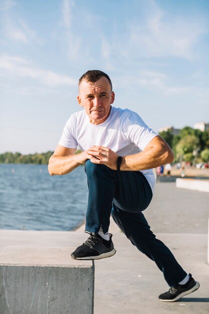 Hombre estirando su pie al aire libre