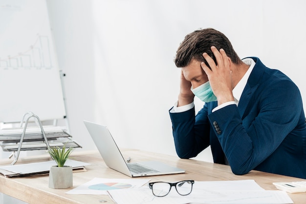 Hombre estresado de tiro medio con laptop