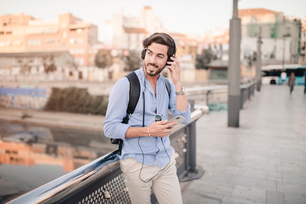 Hombre feliz escuchando música con teléfono móvil