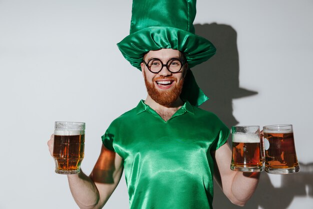 Hombre feliz en traje de patriotas con tazas