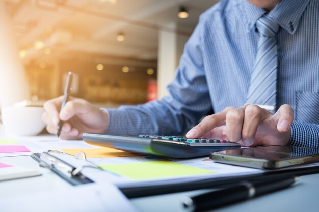 Hombre de finanzas de negocios calculando los números de presupuesto, facturas y asesor financiero trabajando.