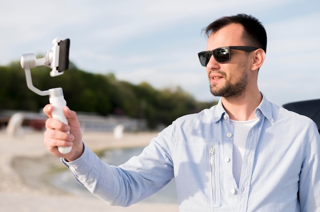 Foto gratuita hombre grabando a sí mismo tiro medio