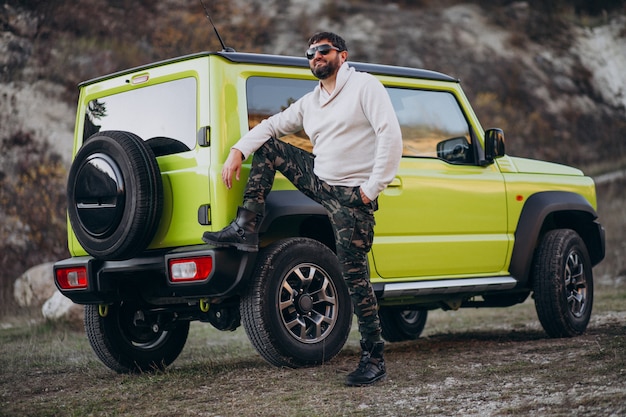 Foto gratuita hombre guapo joven que viaja en coche