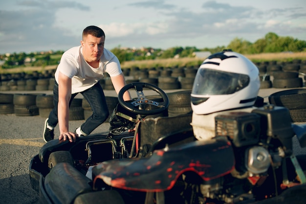 Hombre guapo en un karting con un auto