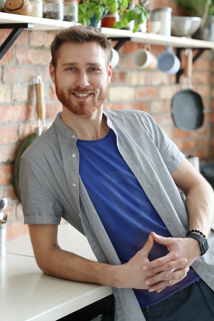 Foto gratuita hombre guapo posando en la cocina