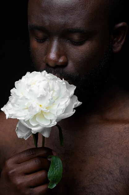 Hombre guapo y sensible con flor.