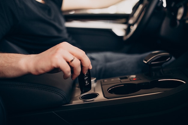 Foto gratuita hombre guapo sentado en el coche y probarlo