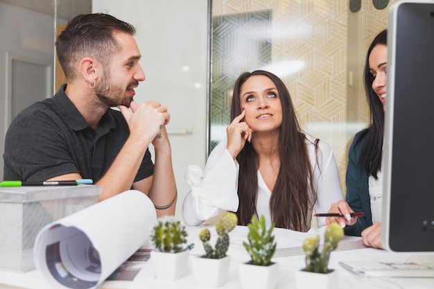 Hombre hablando con mujeres en la oficina