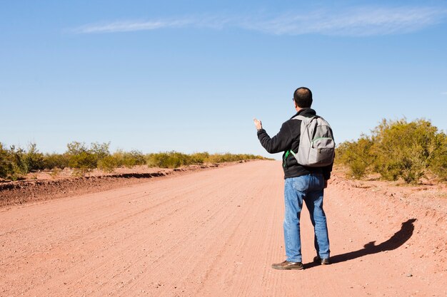 Hombre haciendo autostop en la carretera