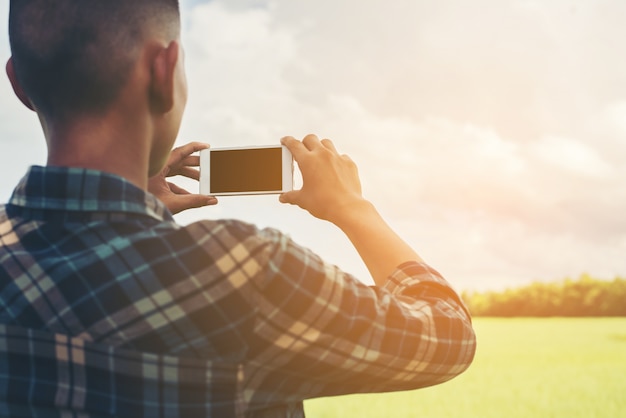 Foto gratuita hombre haciendo una foto del campo