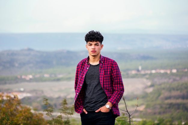 Foto gratuita hombre hermoso joven elegante del viajero que se coloca de mirada de la cámara